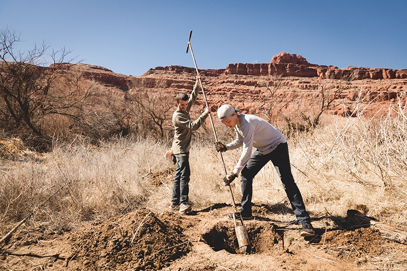 Two students plant trees as part of conservation efforts in Moab, Utah.